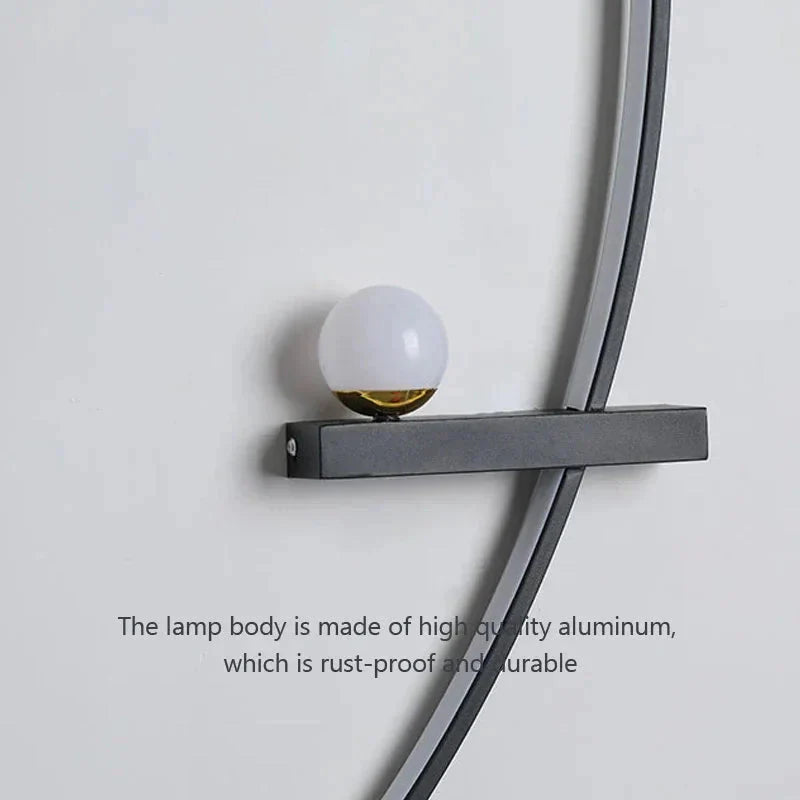 Modern wall sconce with frosted glass globe and matte black aluminum frame for cozy home lighting