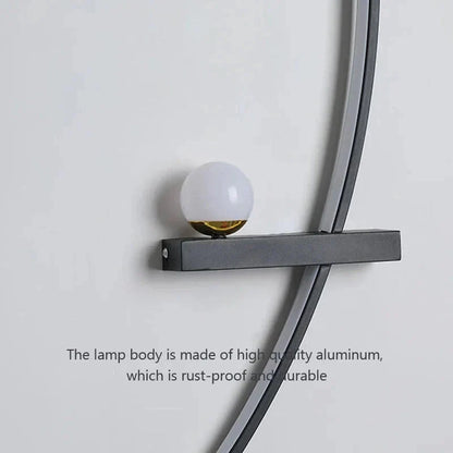 Modern wall sconce with frosted glass globe and matte black aluminum frame for cozy home lighting
