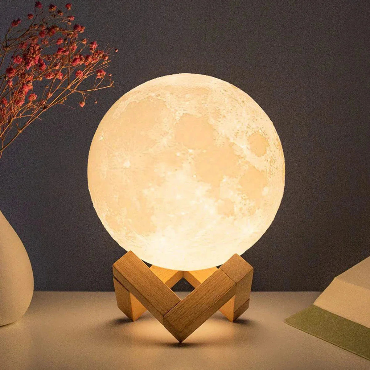 Glowing 3D moon lamp on wooden stand, cozy bedroom nightlight decor