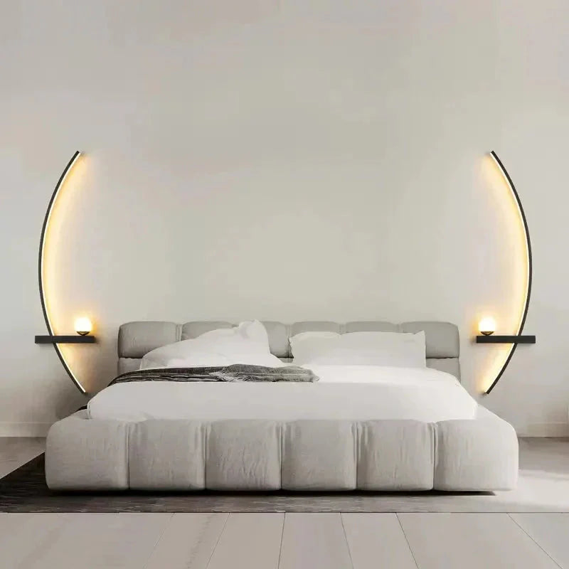 Modern gray upholstered bed with curved wall sconces, cozy white bedding, minimalist bedroom decor
