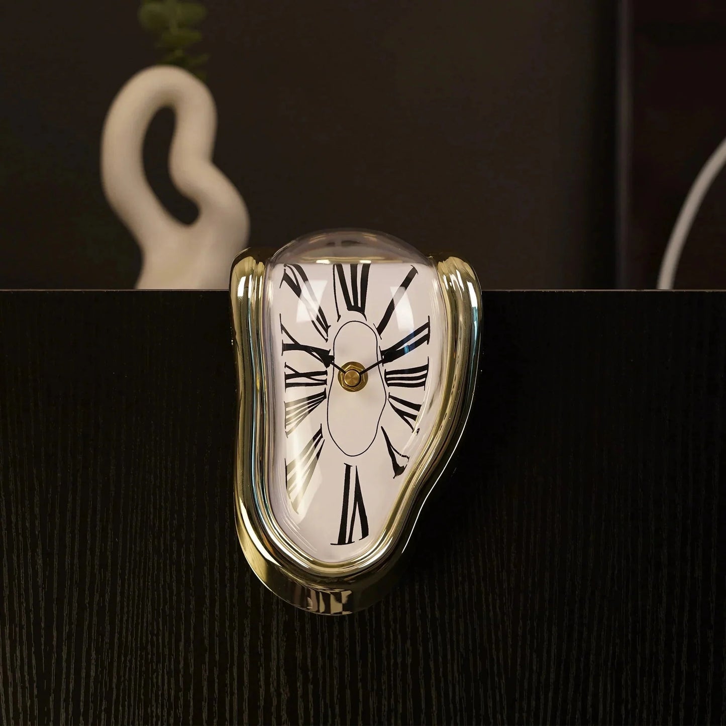 Surreal melting clock with gold frame and Roman numerals, modern home decor accent