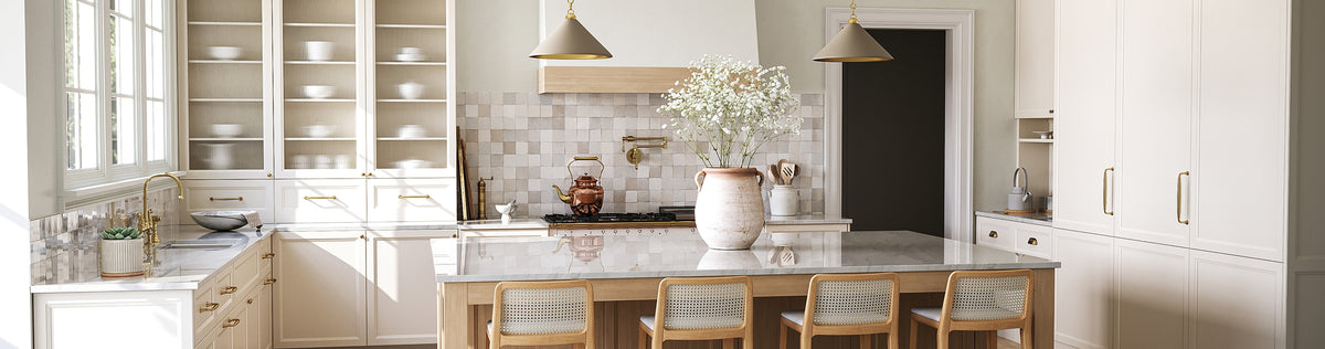 Bright modern kitchen with white cabinets, marble island, gold fixtures, and cane chairs for a cozy home