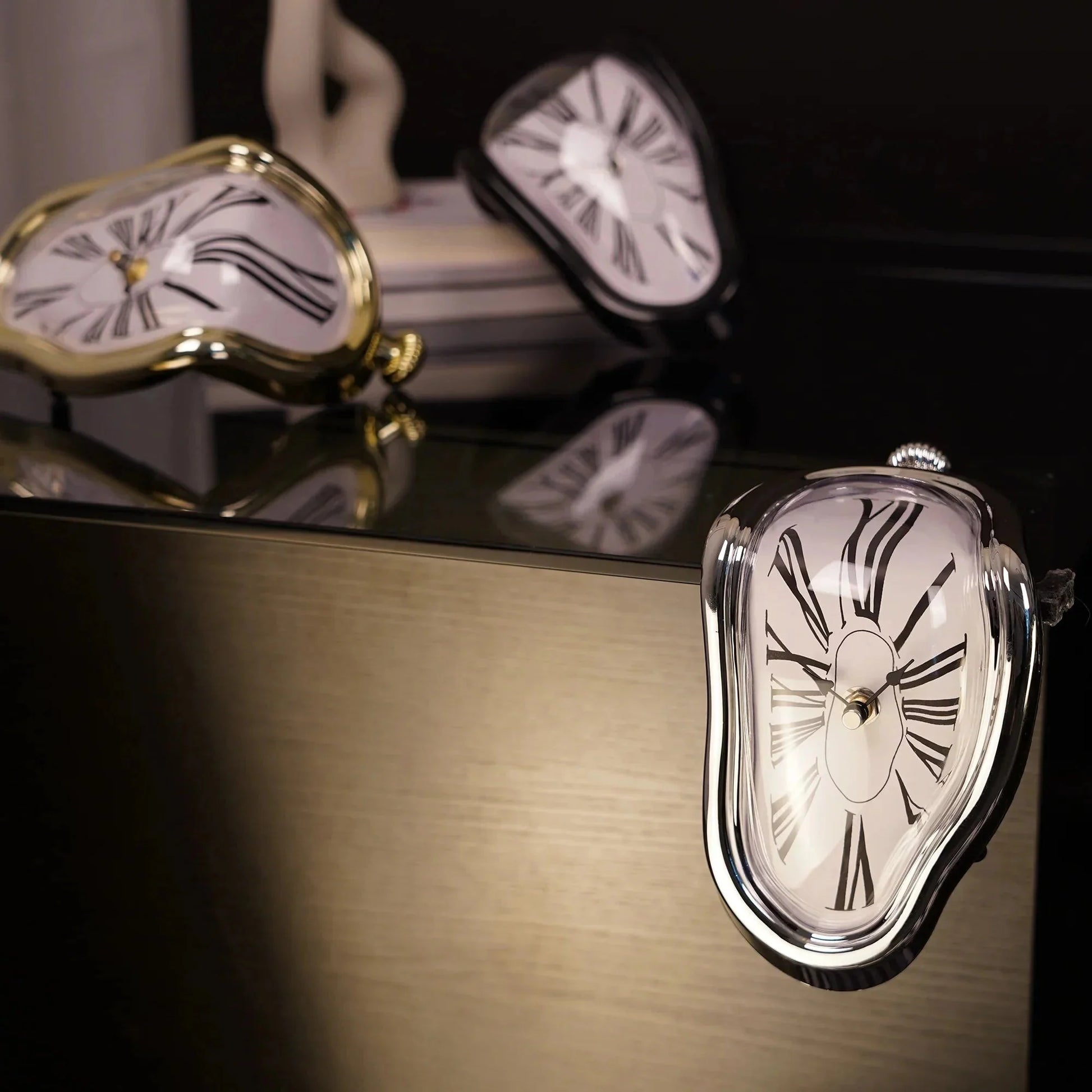 Surreal melting clock decor with Roman numerals, gold and silver frames, modern home accent piece